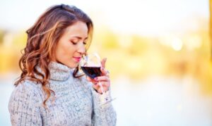 A woman drinking a glass of wine