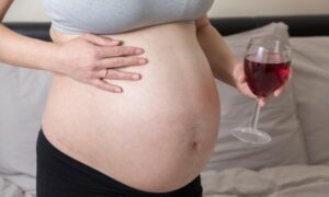 Pregnant woman drinking wine