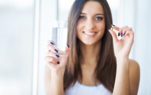 A woman drinking vitamin