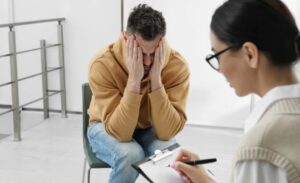 A man at the doctor's office facing an alcohol use disorder (AUD)